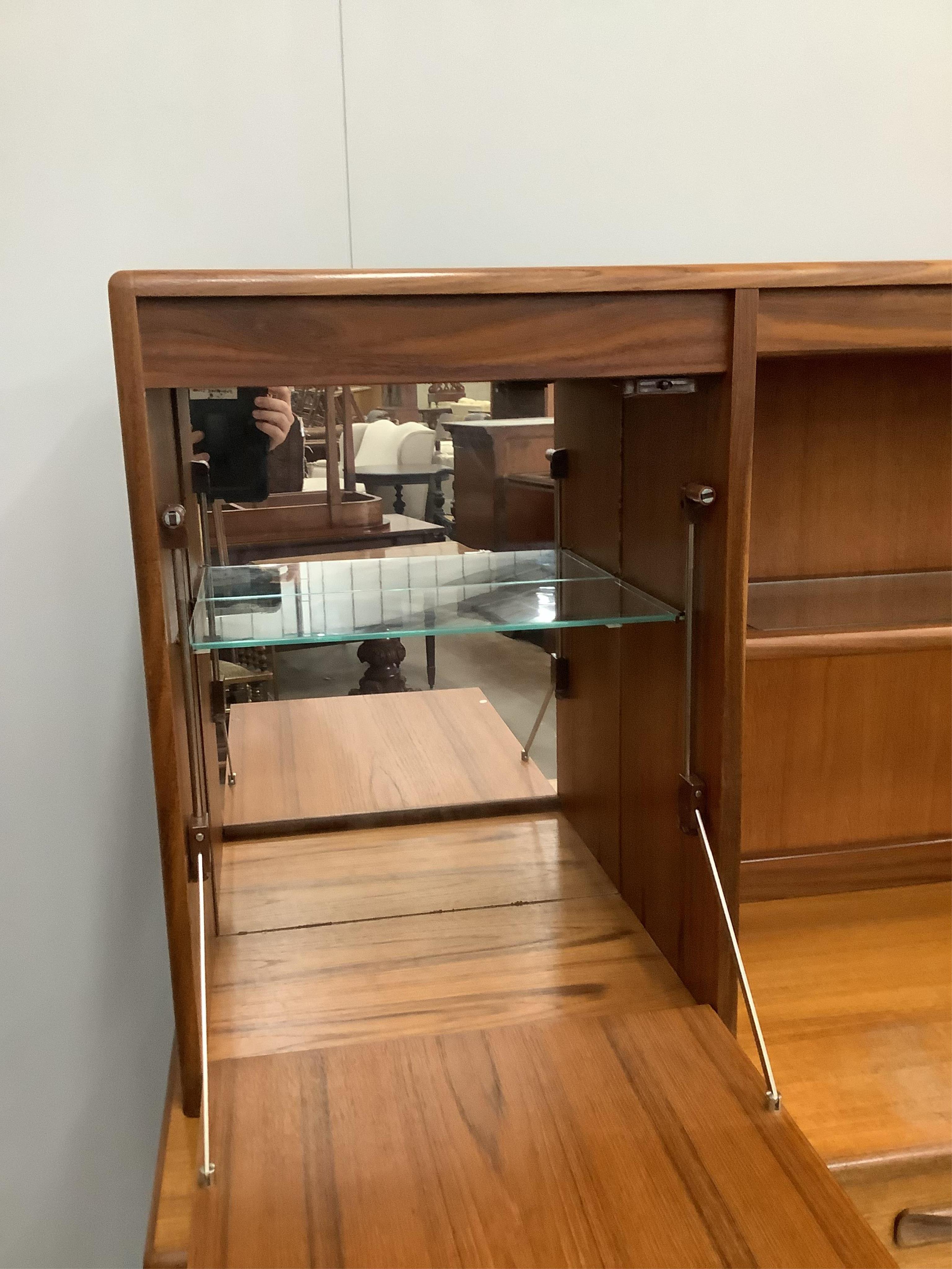 A mid century G Plan teak sideboard, width 142cm, depth 44cm, height 140cm. Condition - fair